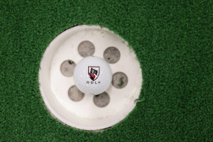 A CMU golf ball in a hole