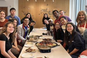 Nevine Abraham and students in her fall 2023 class share a Friendsgiving dinner.