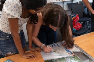 Students in the English Department’s Writing & Culture Pre-College Program work on their poster presentations in class.